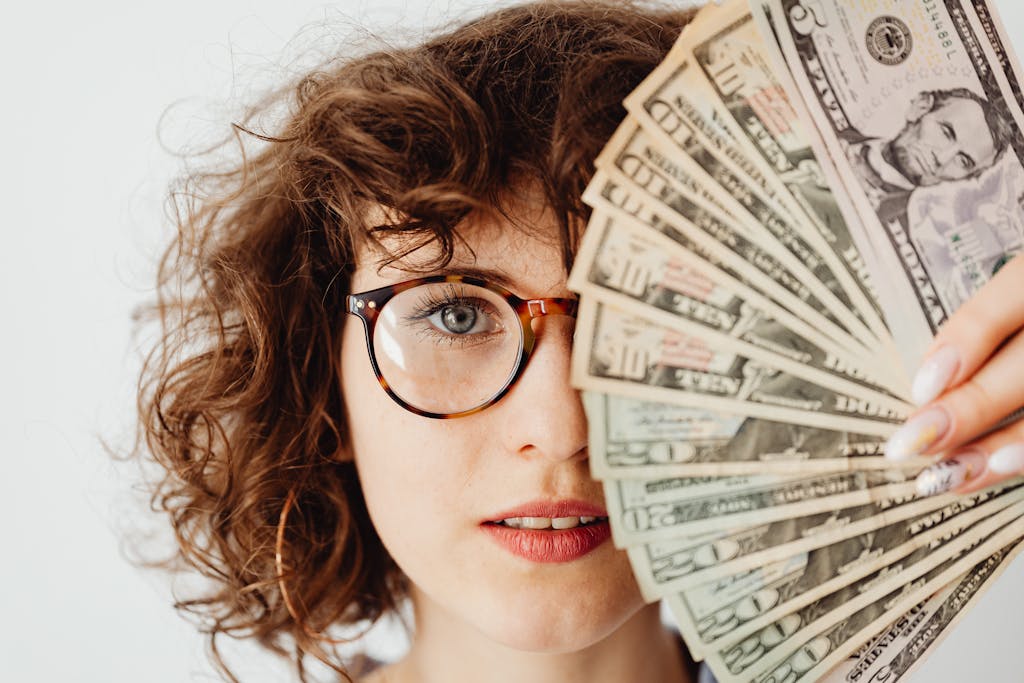 a woman holding a fan of money